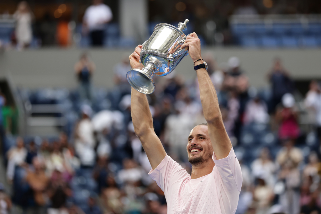 Alexander Zverev, of Germany, poses with the trophy after he won the men's singles final of the U.S. Open tennis championships against Ben Shelton, of the United States, Sunday, Sept. 13, 2026, in New York. (AP Photo/Adam Hunger)