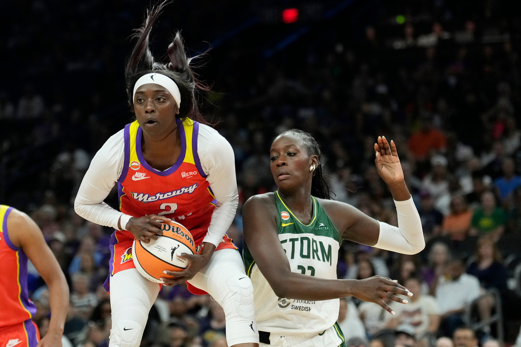 Phoenix Mercury guard Kahleah Copper, left, grabs a rebound in front of Seattle Storm center Awa Fam, right, during the first half of a WNBA basketball game, Thursday, July 2, 2026, in Phoenix. (AP Photo/Ross D. Franklin)
