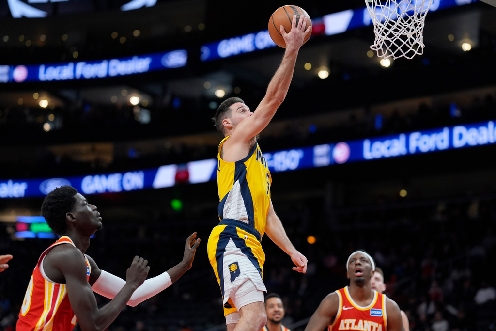 Indiana Pacers guard T.J. McConnell (9) shoots against the Atlanta Hawks during the first half of an NBA basketball game, Monday, Jan. 26, 2026, in Atlanta. (AP Photo/Mike Stewart)