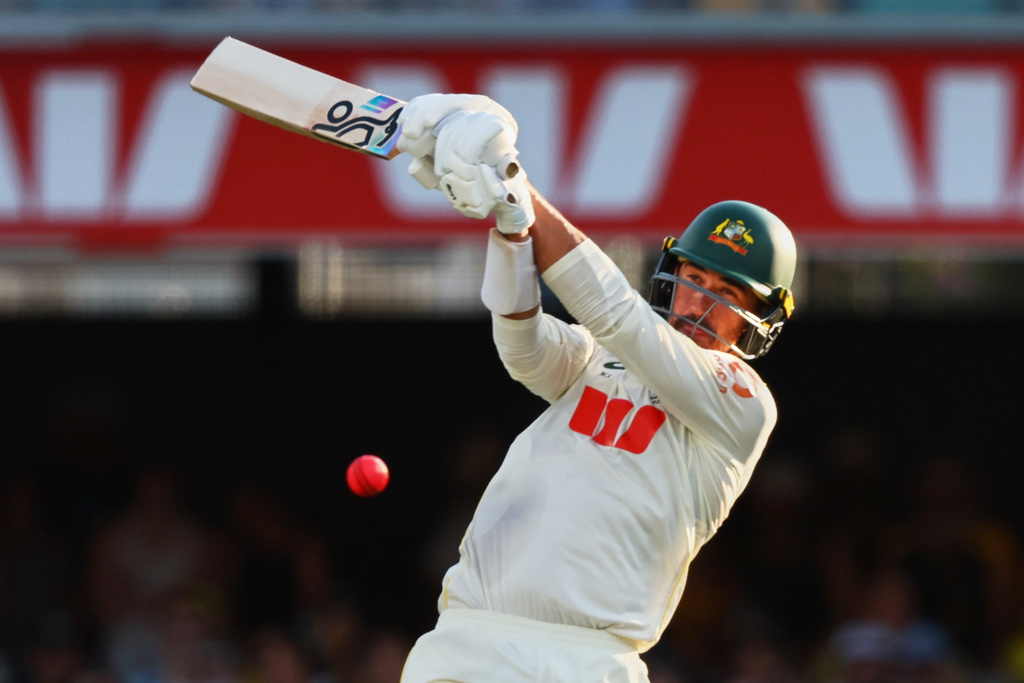 Australia's Mitchell Starc plays a shot during the second Ashes cricket test match between Australia and England in Brisbane, Saturday, Dec. 6, 2025.. (AP Photo/Tertius Pickard)