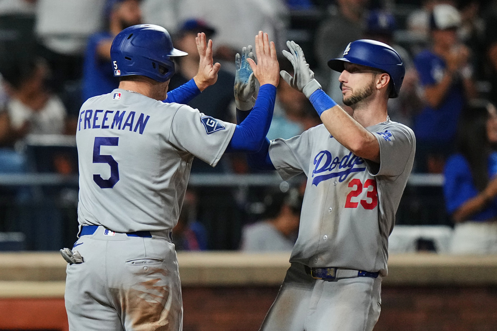 Los Angeles Dodgers' Kyle Tucker (23) celebrates with Freddie Freeman (5) after they scored on two-run home run by Tucker during the eighth inning of a baseball game against the New York Mets Friday, July 24, 2026, in New York. (AP Photo/Frank Franklin II)