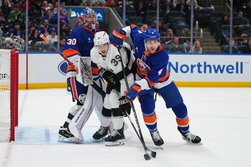 Los Angeles Kings' Jeff Malott (39) fights for position with New York Islanders' Carson Soucy (4) and goaltender Ilya Sorokin (30) during the third period of an NHL hockey game Friday, March 13, 2026, at UBS Arena in Elmont, N.Y. (AP Photo/Frank Franklin II)