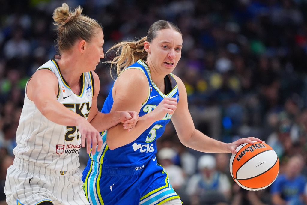 Dallas Wings guard Paige Bueckers, right, drives against Chicago Sky guard Courtney Vandersloot, left, during the second half of a WNBA basketball game in Dallas, Sunday, July 12, 2026. (AP Photo/LM Otero)