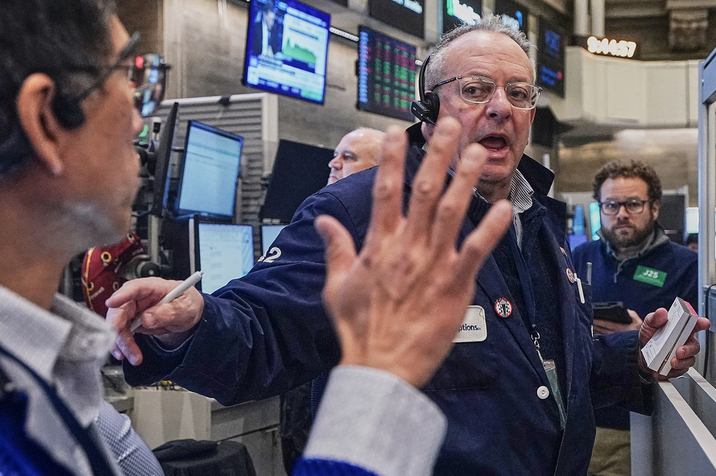 Options trader Phil Fracassini, center, works on the floor of the New York Stock Exchange, Monday, Feb. 2, 2026. (AP Photo/Richard Drew)