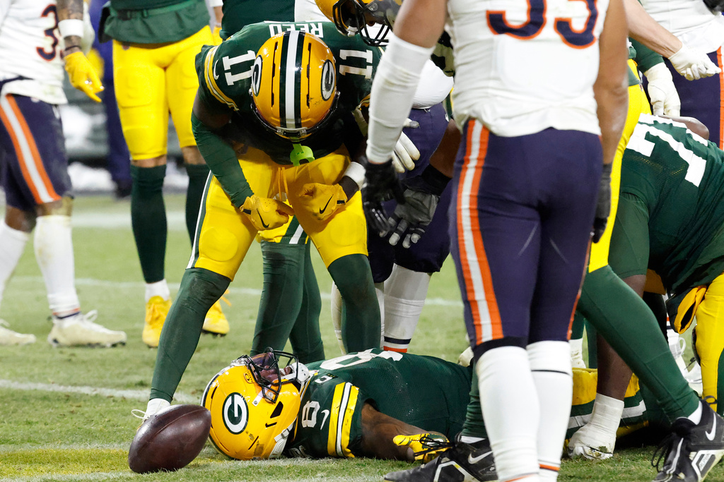 Green Bay Packers running back Josh Jacobs (8) celebrates with wide receiver Jayden Reed (11) after scoring a touchdown against the Chicago Bears during the second half of an NFL football game Sunday, Dec. 7, 2025, in Green Bay, Wis. (AP Photo/Mike Roemer)