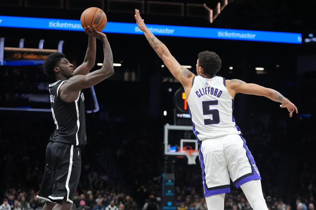 Brooklyn Nets' Drake Powell, left, shoots over Sacramento Kings' Nique Clifford during the second half of an NBA basketball game Sunday, March 29, 2026, in New York. (AP Photo/Frank Franklin II)