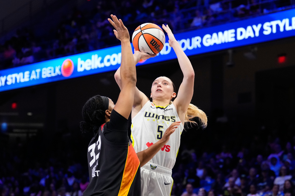 Dallas Wings guard Paige Bueckers (5) shoots as Connecticut Sun's Nell Angloma (33) defends in the first half of a WNBA basketball game Sunday, Aug. 30, 2026, in Arlington, Texas. (AP Photo/Tony Gutierrez)