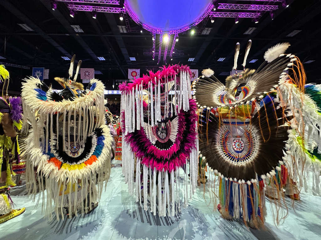 Dancers pause under the arena lights during the grand entry at the last Gathering of Nations powwow in Albuquerque, New Mexico, on Friday, April 24, 2026. (AP Photo/Susan Montoya Bryan)