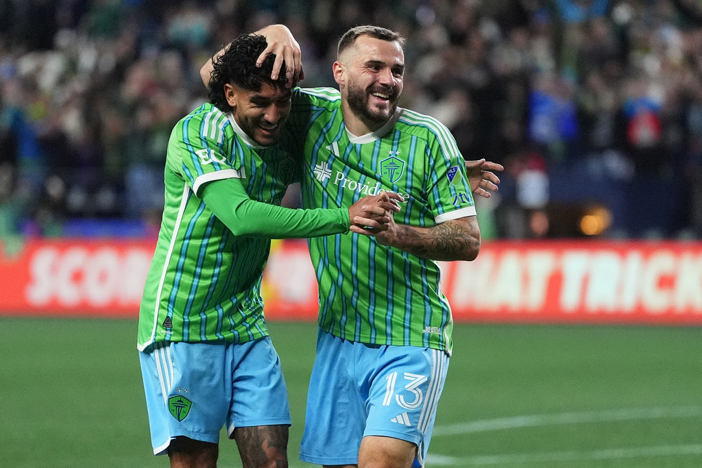 Seattle Sounders forward Jordan Morris, right, celebrates his goal with forward Jesús Ferreira, left, during the first half of Game 2 in the first round of MLS soccer's Western Conference playoffs against Minnesota United, Monday, Nov. 3, 2025, in Seattle. (AP Photo/Lindsey Wasson)