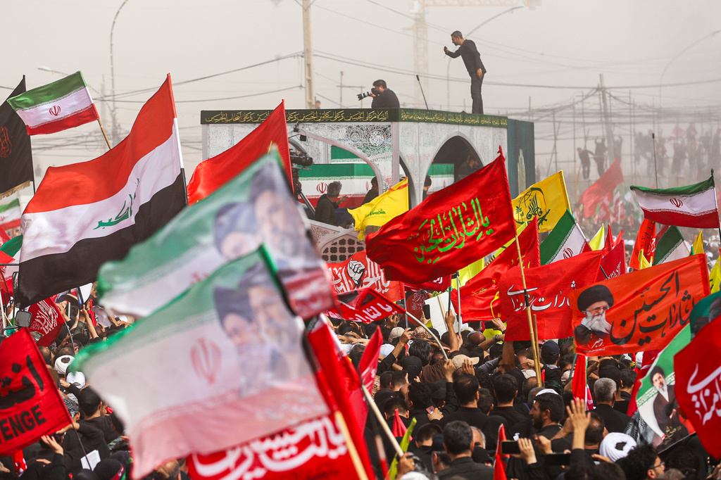 A truck carrying the coffins of the late Iranian Supreme Leader Ayatollah Ali Khamenei and members of his family makes its way through mourners during the funeral procession in Qom, the heart of religious studies in Iran, Tuesday July 7, 2026. (Mohammad Asadi/ISNA via AP)