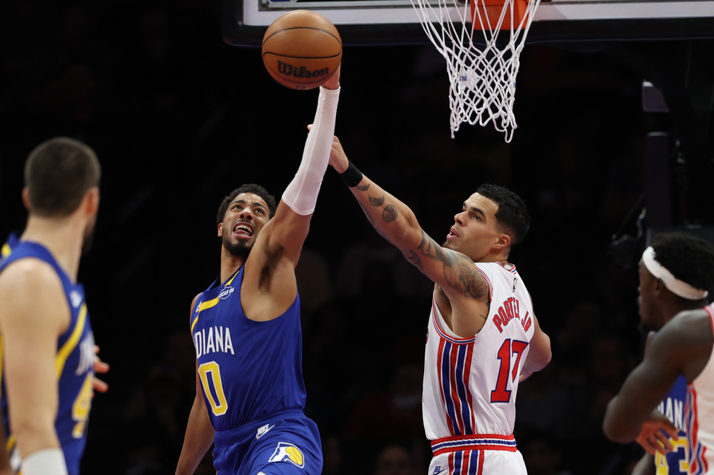 Indiana Pacers' Tyrese Haliburton (0) and Brooklyn Nets' Michael Porter Jr. (17), second from right, compete for a rebound during the first half of an NBA basketball game Sunday, Oct. 25, 2026, in New York. (AP Photo/Pamela Smith)