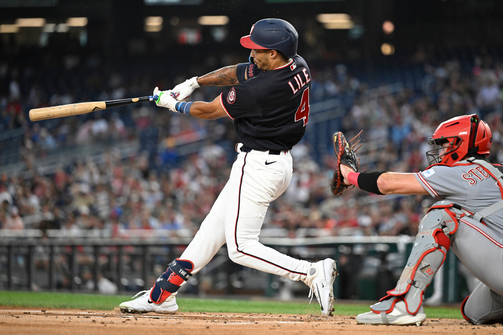 Washington Nationals' Daylen Lile hits a three-run home run during the first inning of a baseball game against the Cincinnati Reds, Friday, Aug. 7, 2026, in Washington. (AP Photo/John McDonnell)