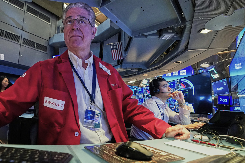 Trader Daniel Kryger, left, works on the floor of the New York Stock Exchange, Monday, June 15, 2026. (AP Photo/Richard Drew)