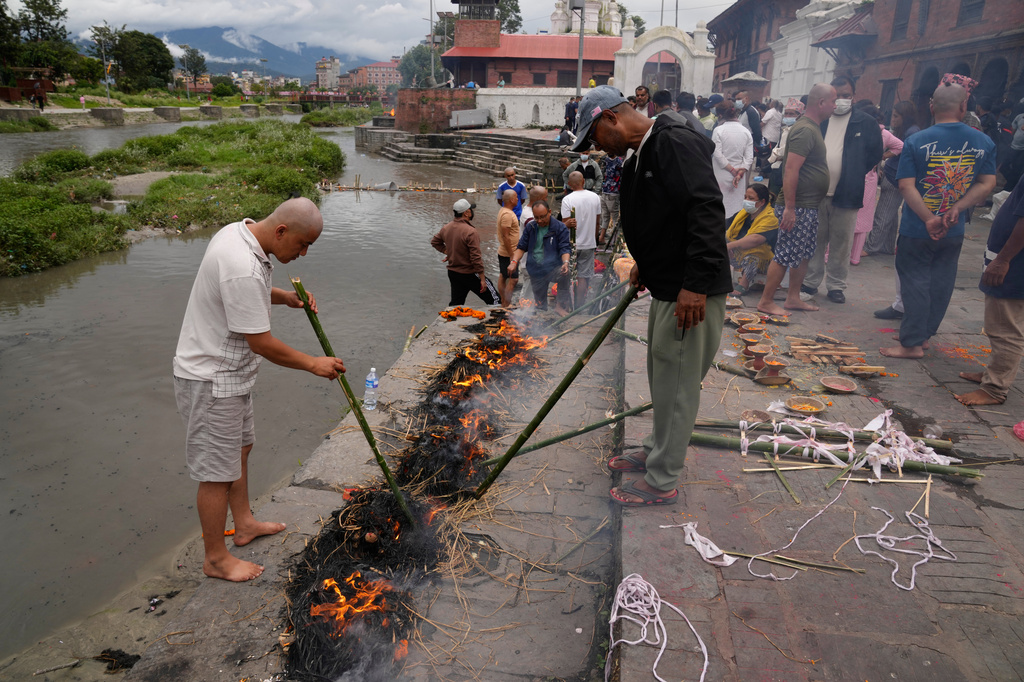 Men perform rituals during symbolic last rites for their relatives who remain missing and are presumed dead following flash floods in Kathmandu, Nepal, Wednesday, Sept. 2, 2026. (AP Photo/Dar Yasin)