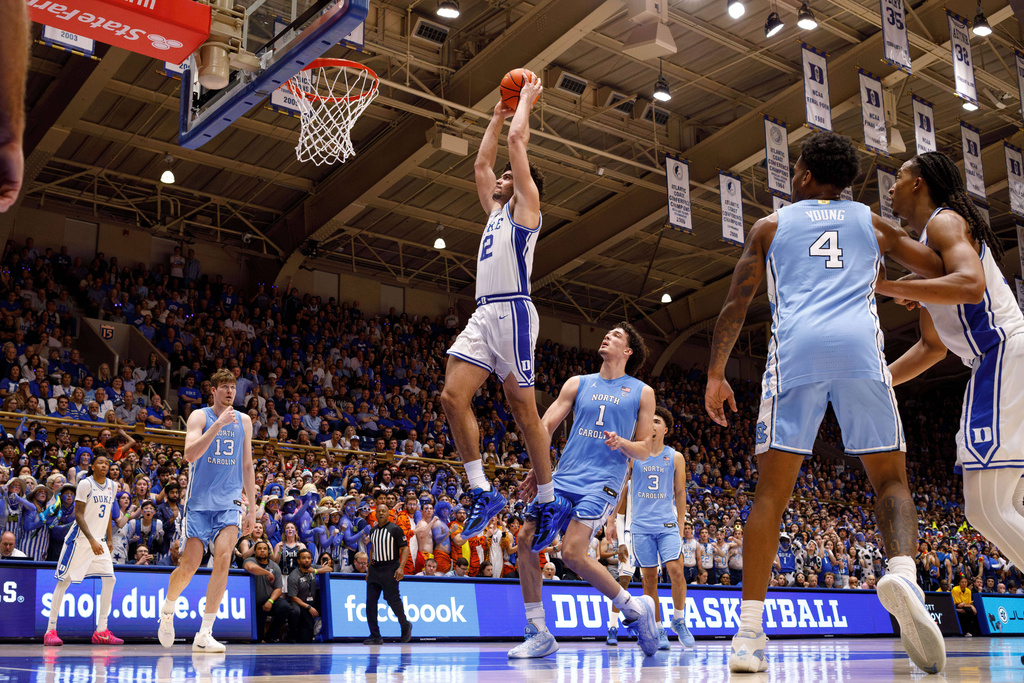 Duke's Cameron Boozer (12) dunks during the second half of an NCAA college basketball game against North Carolina in Durham, N.C., Saturday, March 7, 2026. (AP Photo/Ben McKeown)