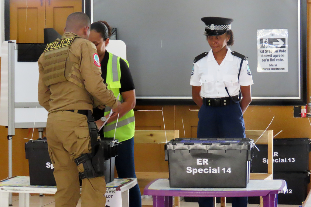 A police officer casts his vote at English River School in Victoria, Seychelles, Thursday, Sept. 25, 2025. (AP Photo/Emilie Chetty)