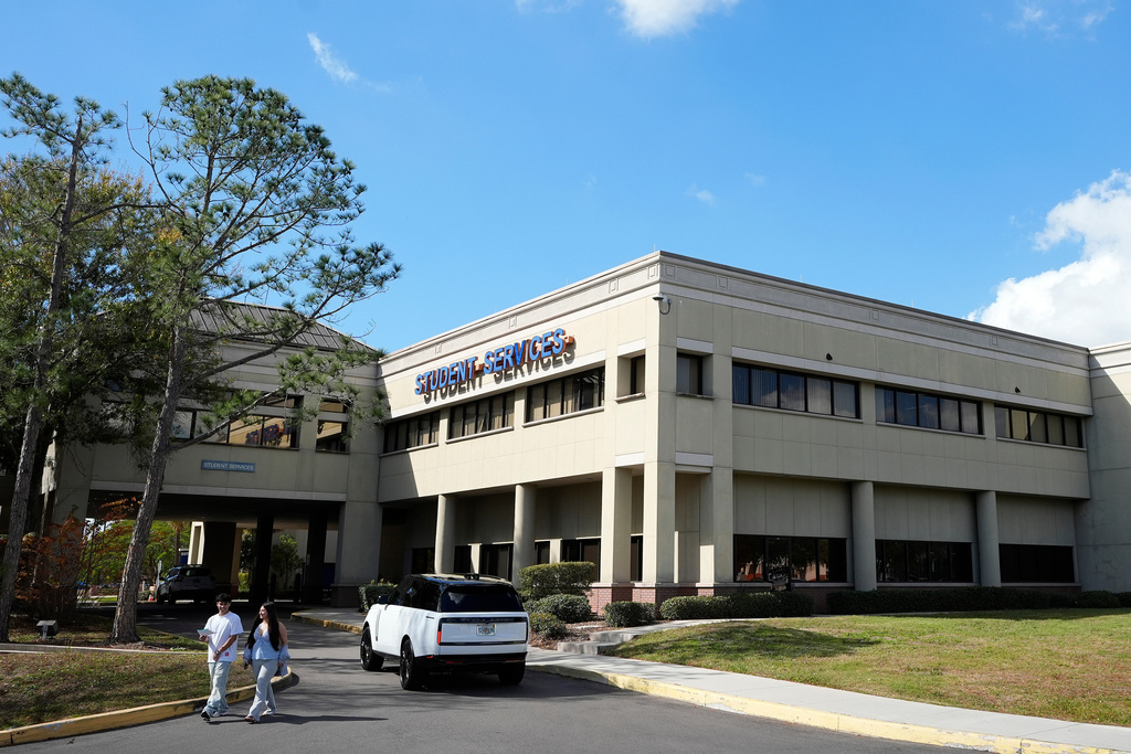 People walk in front of the student services building at Hillsborough Community College, Friday, Jan. 23, 2026, in Tampa, Fla. (AP Photo/Chris O'Meara)