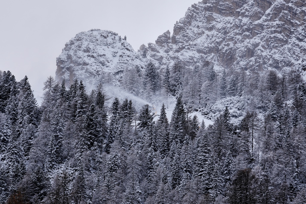 A snow cannon in action on the Olympia delle Tofane course where the women's Alpine skiing will be contested at the 2026 Milan Cortina Winter Olympics, in Cortina D'Ampezzo, Italy, Friday, Nov. 21, 2025. (AP Photo/Andrew Medichini)