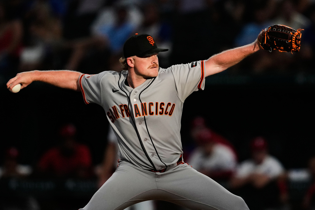 San Francisco Giants pitcher Logan Webb throws to the Texas Rangers in the first inning of a baseball game in Arlington, Texas, Monday, Aug. 3, 2026. (AP Photo/Tony Gutierrez)