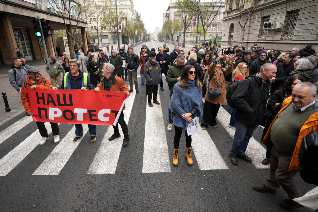 Serbian journalists block the traffic outside the offices of Serbia's President Aleksandar Vucic in Belgrade, Serbia, Wednesday, April 1, 2026, in protest of mounting attacks and pressure on the media. (AP Photo/Darko Vojinovic)