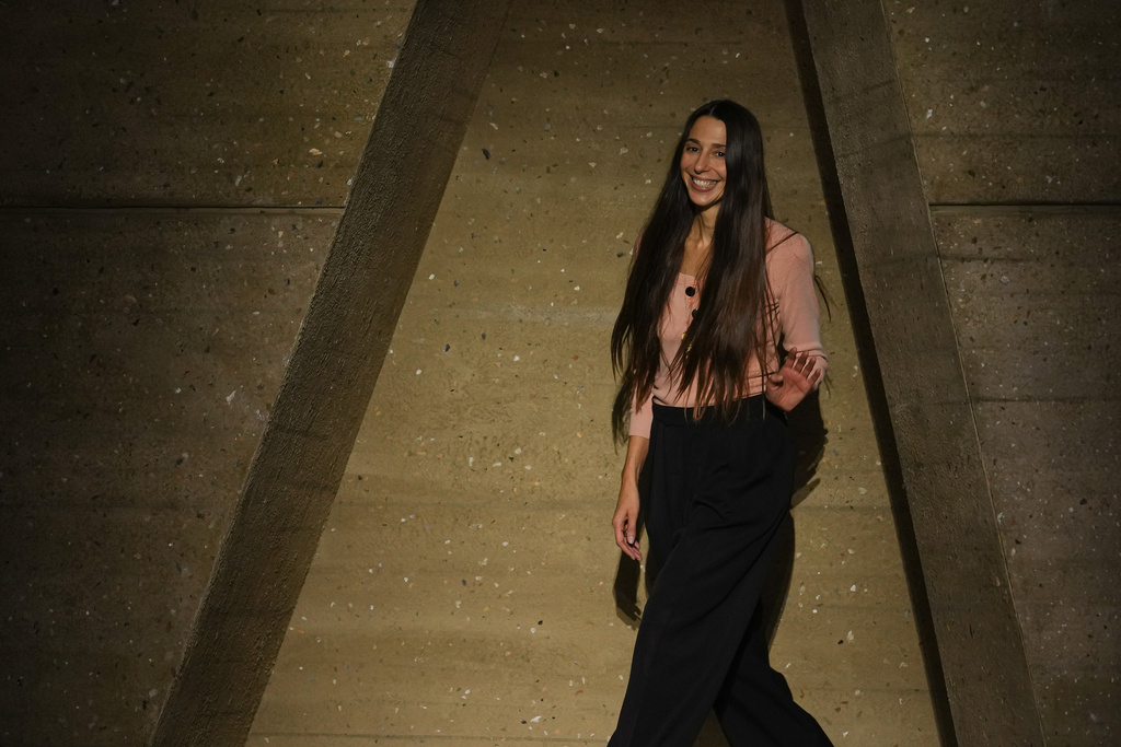 Designer Chemena Kamali acknowledges applause after the Chloe Spring/Summer 2026 collection presented in Paris, Sunday, Oct. 5, 2025. (AP Photo/Aurelien Morissard)