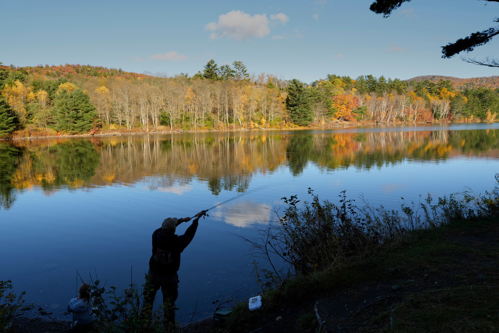 A fisherman casts for trout at Pearl Lake, Tuesday, Oct. 21, 2025, in Lisbon, N.H. (AP Photo/Robert F. Bukaty)