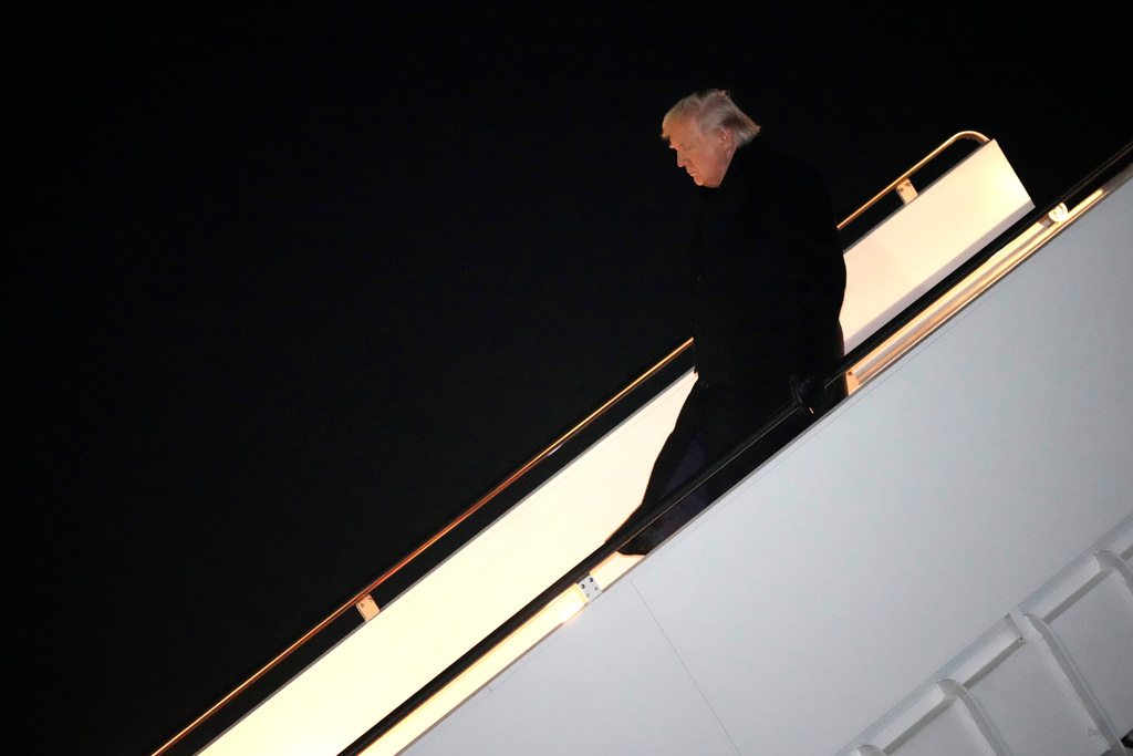 President Donald Trump steps off Air Force One, early Monday, Feb. 9, 2026, at Joint Base Andrews, Md., after returning from a trip to Florida. (AP Photo/Mark Schiefelbein)