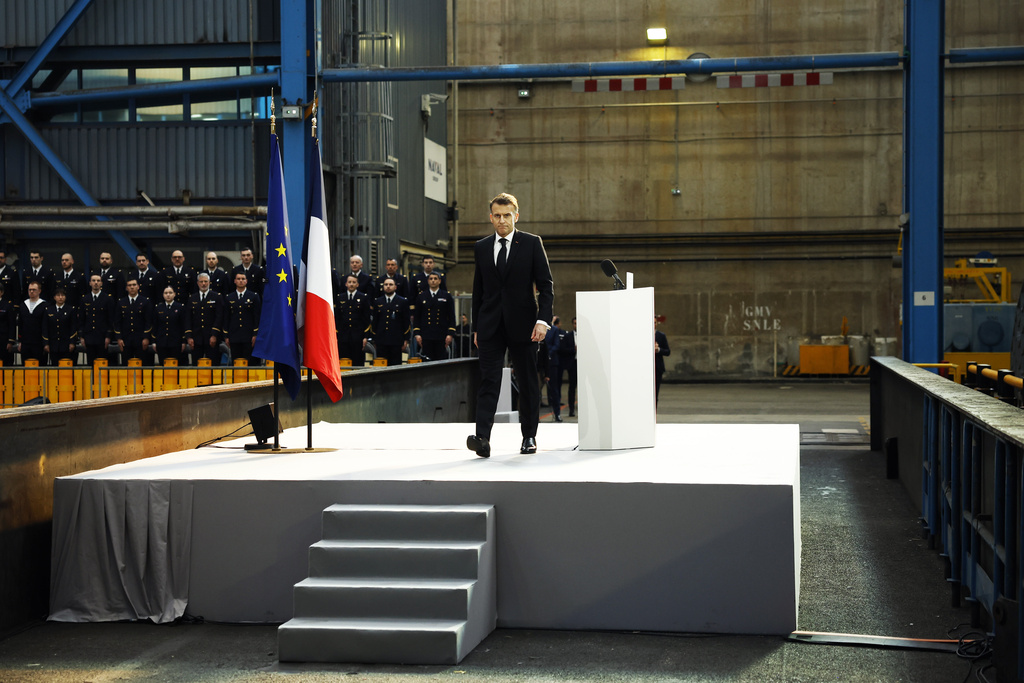 French President Emmanuel Macron leaves the podium afer his speech at the Nuclear submarines Navy base of Ile Longue in Crozon, France, Monday March 2, 2026. (Yoan Valat/Pool Photo via AP)