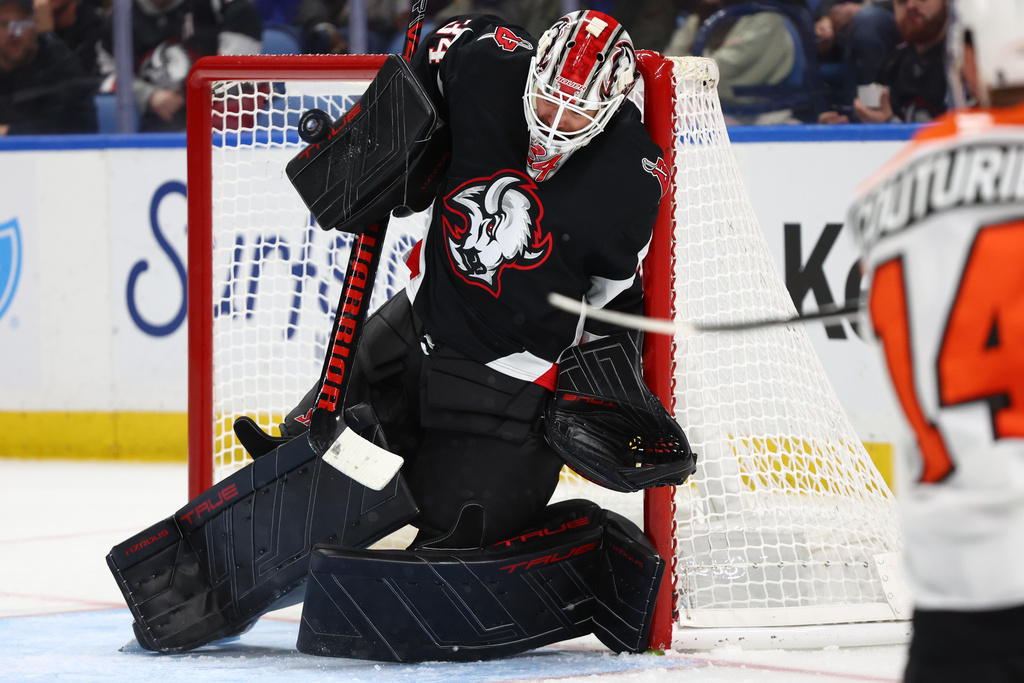 Buffalo Sabres goaltender Alex Lyon makes a save during the second period of an NHL hockey game against the Philadelphia Flyers, Thursday, Dec. 18, 2025, in Buffalo, N.Y. (AP Photo/Jeffrey T. Barnes)