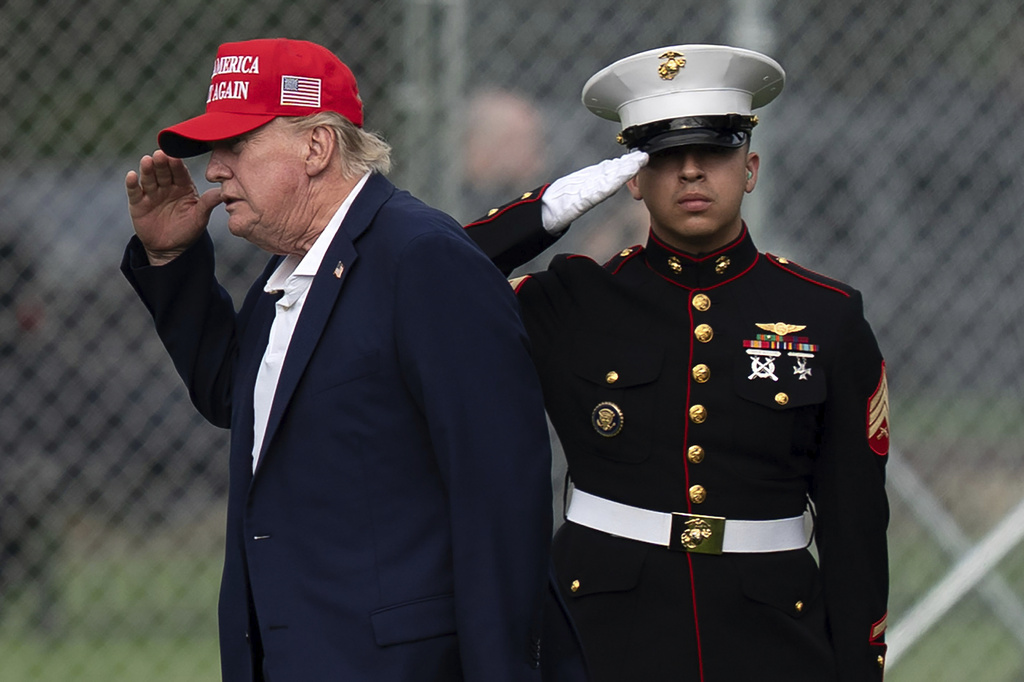 President Donald Trump returns a salute as he walks from Marine One to his limousine upon his arrival at the Ellipse just outside of the White House, Sunday, Aug. 16, 2026, in Washington. (AP Photo/Jose Luis Magana)