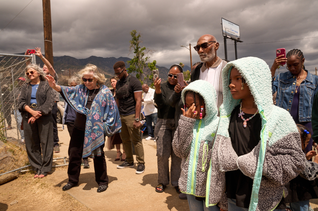 Members of the congregation pray during a groundbreaking service at the site of the burned Fountain of Life Nazarene Church, marking the beginning of its rebuilding, April 26, 2026, in Altadena, Calif. (AP Photo/Damian Dovarganes)