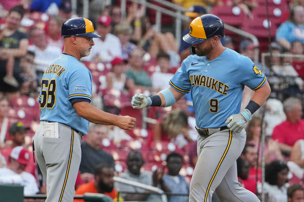 Milwaukee Brewers' Jake Bauers (9) is congratulated by third base coach Matt Erickson after hitting a three-run home run during the third inning of a baseball game Thursday, July 9, 2026, in St. Louis. (AP Photo/Jeff Roberson)