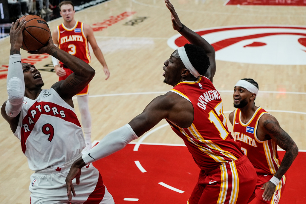 Toronto Raptors forward RJ Barrett (9) shoots against Atlanta Hawks forward Onyeka Okongwu (17) during the first half of an NBA basketball game, Wednesday, Oct. 22, 2025, in Atlanta. (AP Photo/Mike Stewart)