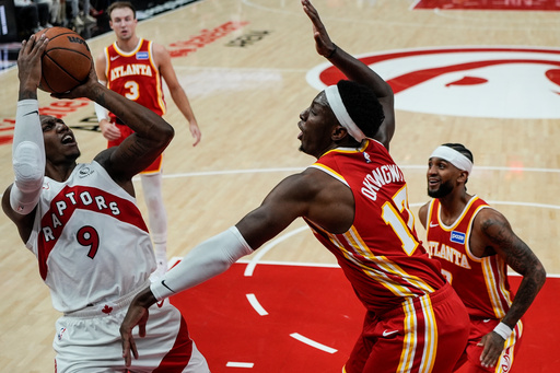 Toronto Raptors forward RJ Barrett (9) shoots against Atlanta Hawks forward Onyeka Okongwu (17) during the first half of an NBA basketball game, Wednesday, Oct. 22, 2025, in Atlanta. (AP Photo/Mike Stewart) Toronto Raptors forward RJ Barrett (9) shoots against Atlanta Hawks forward Onyeka Okongwu (17) during the first half of an NBA basketball game, Wednesday, Oct. 22, 2025, in Atlanta. (AP Photo/Mike Stewart)