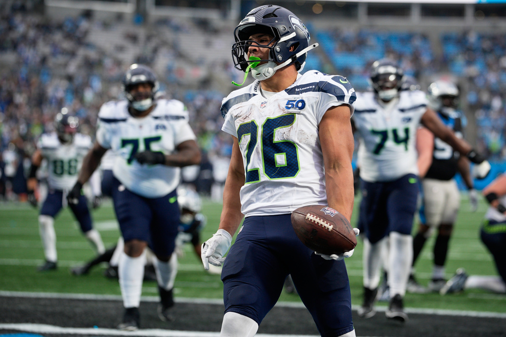 Seattle Seahawks running back Zach Charbonnet celebrates after scoring against the Carolina Panthers during the second half of an NFL football game, Sunday, Dec. 28, 2025, in Charlotte, N.C. (AP Photo/Jacob Kupferman)