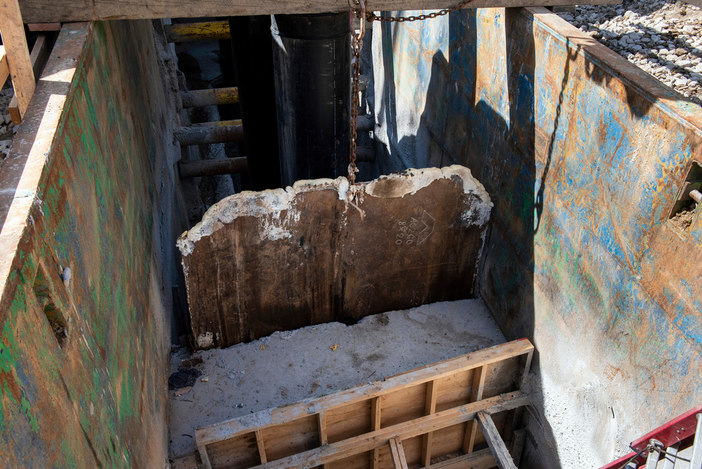 A gate is raised, allowing raw sewage to flow to an interceptor pipe along the C&O Canal, beside the Potomac River, in Cabin John, Md., Saturday, March 14, 2026. (AP Photo/Cliff Owen)