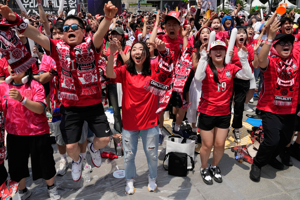 South Korean soccer fans react as they watch a live broadcasting of the Group A World Cup soccer match between South Korea and Czechia in Mexico, at a public viewing venue in Seoul, South Korea, Friday, June 12, 2026. (AP Photo/Ahn Young-joon)