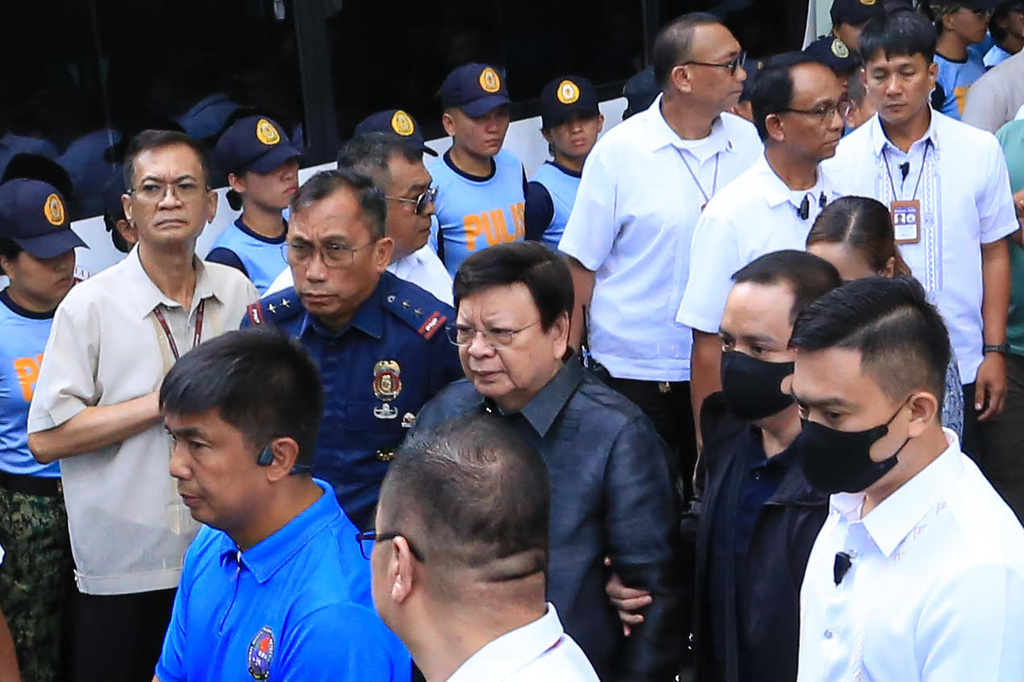 Philippine Sen. Rodante Marcoleta, center, is escorted by police at the Sandiganbayan special anti-graft court as being arrested for alleged plunder, a non-bailable offense, in Quezon city, Philippines on Monday, July 6, 2026. (AP Photo)