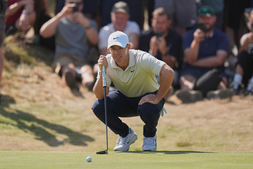 Rory McIlroy of Northern Ireland looks at the lie of his putt on the 1st green during the first day of the British Open Golf championships at Royal Birkdale golf club, in Southport, England, Thursday, July 16, 2026. (AP Photo/David Goldman)