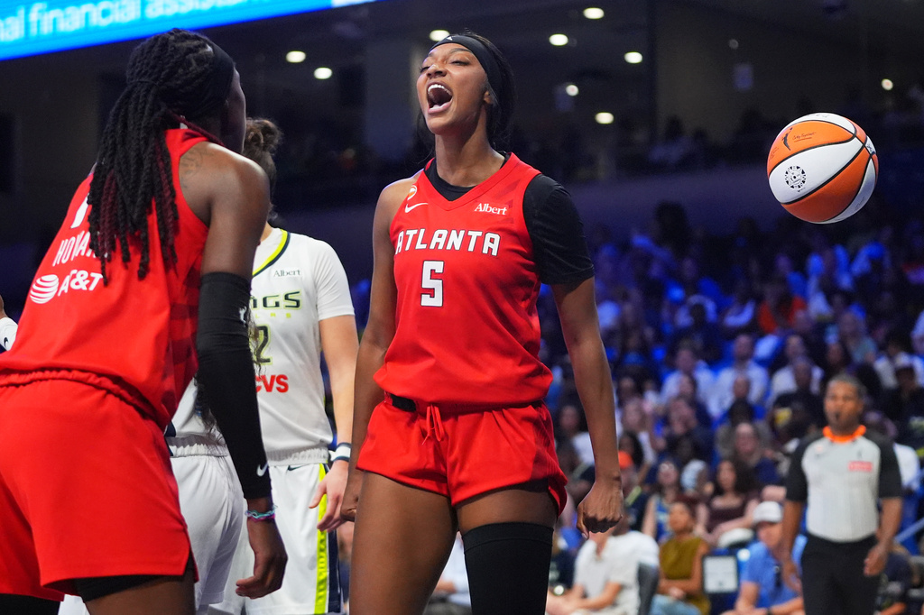 Atlanta Dream forward Angel Reese (5) reacts to scoring with teammate Rhyne Howard (10) during the second half of a WNBA basketball game against the Dallas Wings in Arlington, Texas, Wednesday, July 29, 2026. (AP Photo/LM Otero)