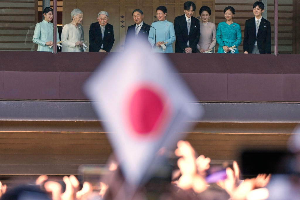 FILE - Japan's Emperor Naruhito, fourth left, Empress Masako, fifth left, and other royal family members greet well-wishers from the balcony during a public appearance for New Year's celebrations at the Imperial Palace, Jan. 2, 2026, in Tokyo. (AP Photo/Eugene Hoshiko, File)