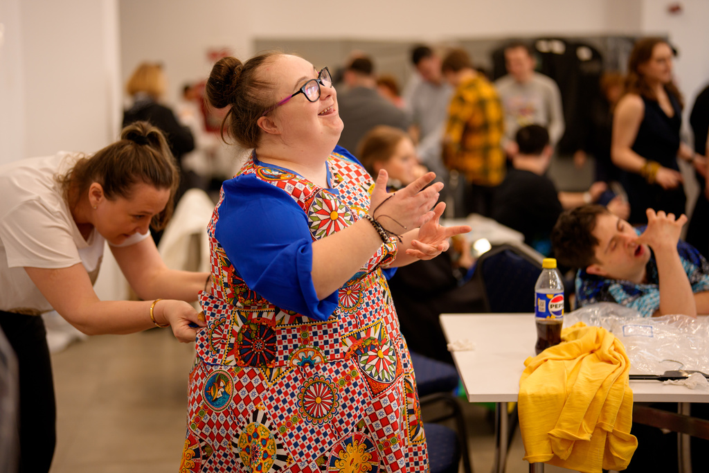 Alexandra Racatej tries on her outfit before the SEEN Anonymous Seamstresses Gala, an event organised by the Down Plus Bucharest, an NGO supporting youngsters with Down Syndrome and other intellectual disabilities, in Bucharest, Romania, Wednesday, March 18, 2026, ahead of the World Down Syndrome Day, on March 21. (AP Photo/Andreea Alexandru)