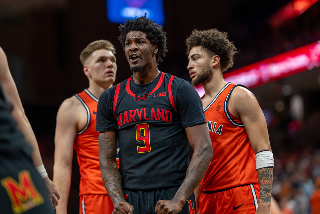 Maryland forward Solomon Washington (9) celebrates with a teammate, left, during the first half of an NCAA college basketball game against Virginia, Saturday, Dec. 20, 2025, in Charlottesville, Va. (AP Photo/Robert Simmons)