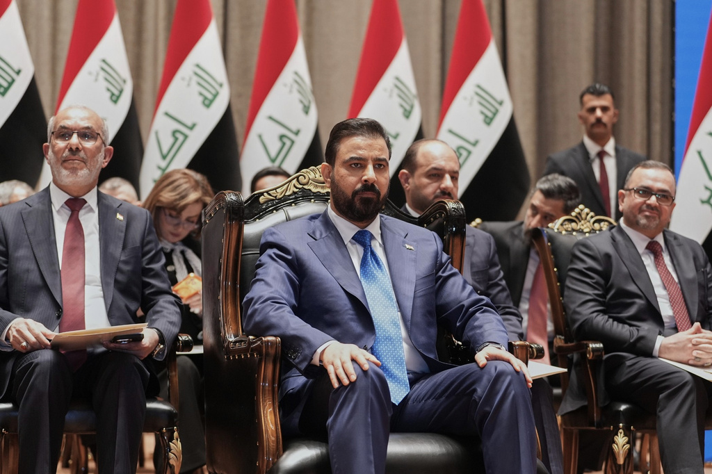 Iraq's Prime Minister-designate Ali al-Zaidi, center, attends the Parliament session to submit his government in Baghdad, Iraq, Thursday, May 14, 2026. (Iraqi Presidency Office via AP)