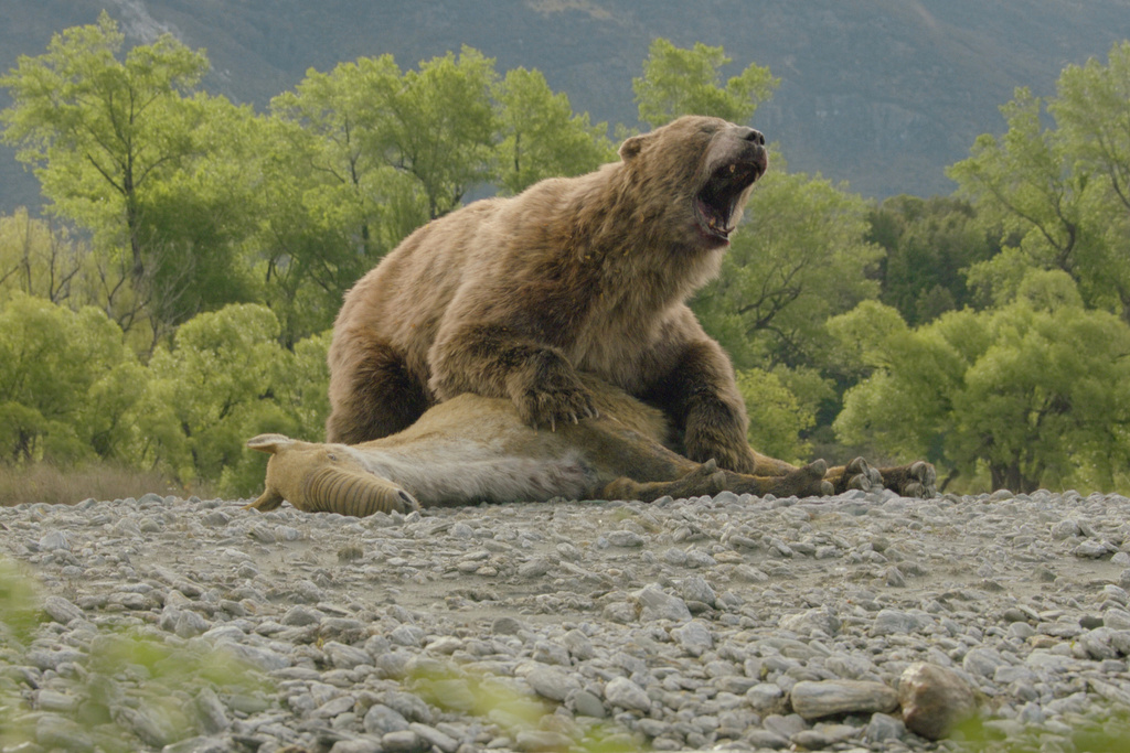 This computer generated image released by Apple TV shows the Arctotherium angustidens, the biggest bear to ever live, in a scene from “Prehistoric Planet: Ice Age." (Apple TV via AP)