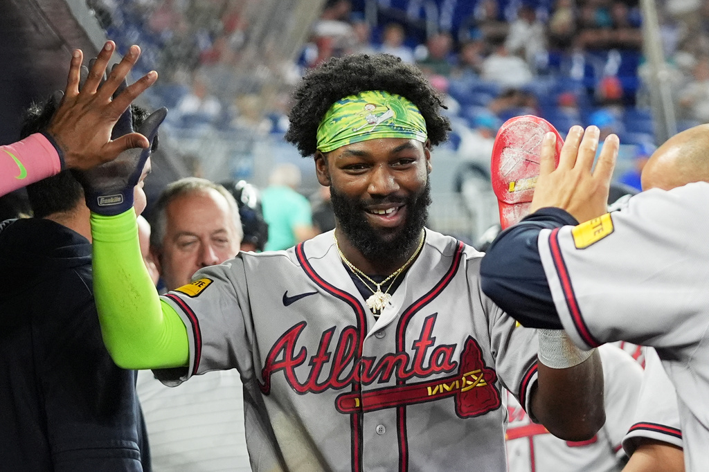 Atlanta Braves' Michael Harris II is congratulated after scoring on a sacrifice fly hit by Matt Olson during the first inning of a baseball game against the Miami Marlins, Saturday, Sept. 26, 2026, in Miami. (AP Photo/Lynne Sladky)