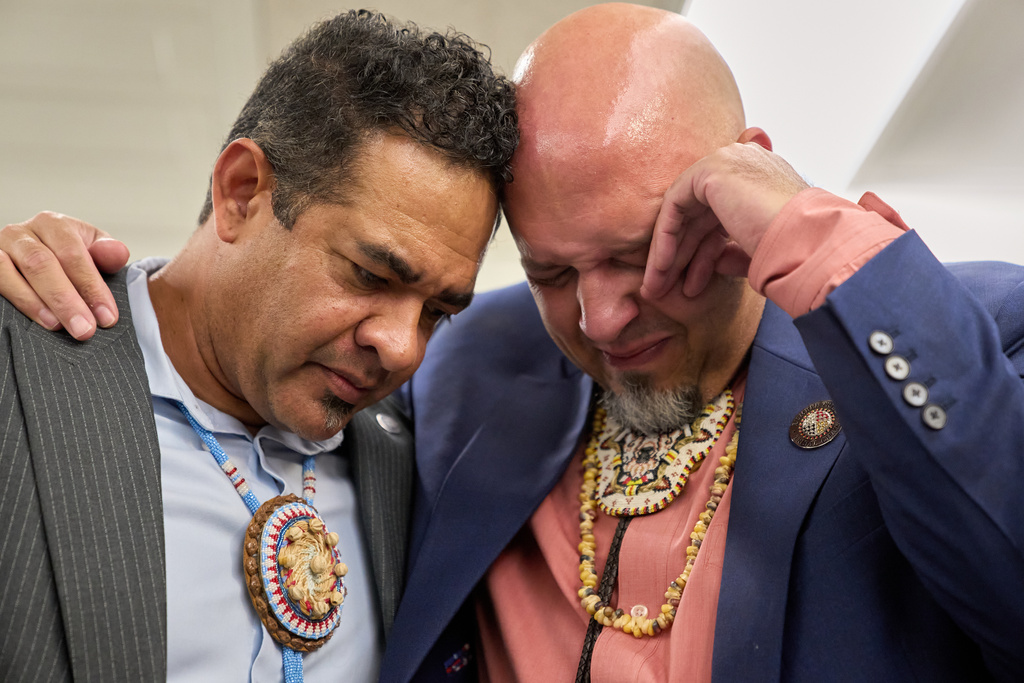 John Lowery, N.C. State Rep. and Chairman of the Lumbee Tribe of N.C., right, is comforted by Rob Jacobs, as they join with other members of the Lumbee Tribe of North Carolina, to celebrate with hugs, tears, and prayers after the passage of a bill granting their people with federal recognition, on Capitol Hill, in Washington, Wednesday, Dec. 17, 2025. "It means a lot," says Lowery, "because we have been figuring out how to get here for so long. We have been second class natives, and we will never be that again. We will make sure this counts." (AP Photo/Jacquelyn Martin)