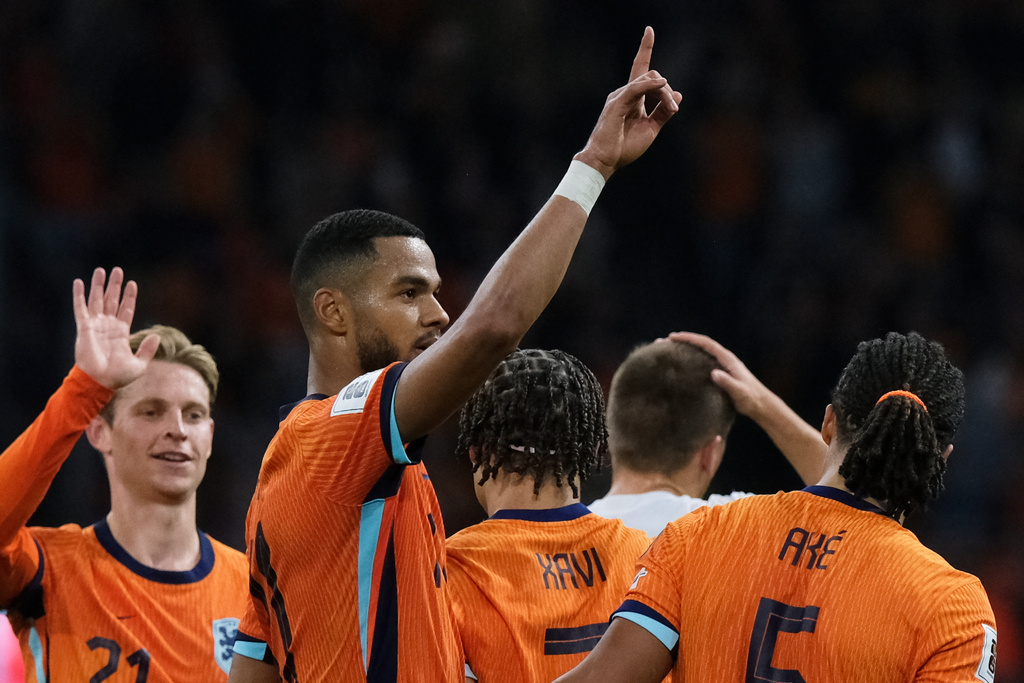 Netherlands' Cody Gakpo, center, celebrates after scoring his side's fourth goal during a World Cup 2026 group G qualifying soccer match between the Netherlands and Finland in Amsterdam, Sunday, Oct. 12, 2025. (AP Photo/Patrick Post)
