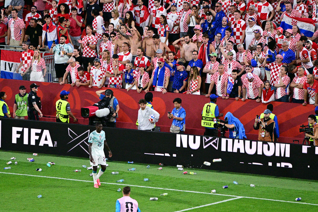 Croatia fans toss bottles and cans on the field after a Croatia goal was disallowed goal during the World Cup round of 32 soccer match between Portugal and Croatia in Toronto, Thursday, July 2, 2026. (Sammy Kogan/The Canadian Press via AP)