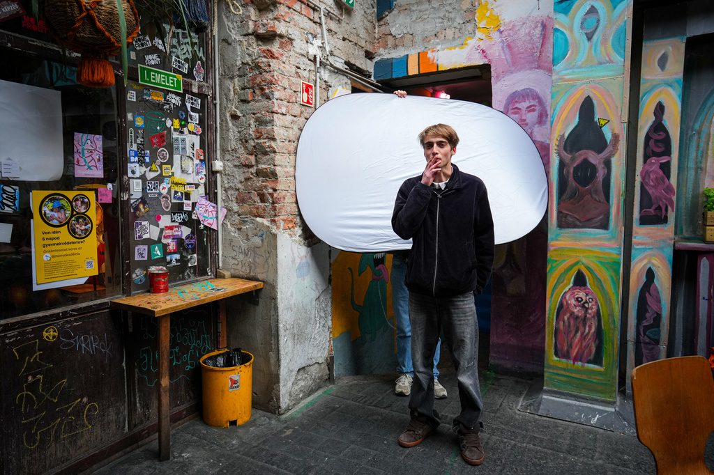Gusztav Komaromy, 22, poses for a portrait as he smokes a cigarette in Budapest, Hungary, Monday, April 13, 2026. "We had a regime that took control of our lives and political consciousness. We had to take a stance about propaganda, about political cynicism, about the state of the public sphere. " (AP Photo/Petr David Josek)